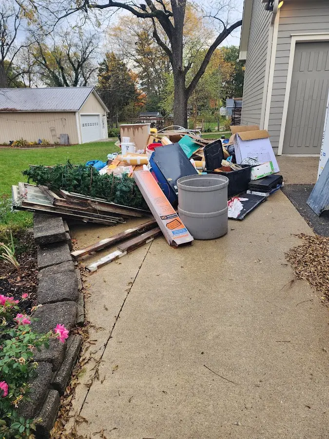 Dumpster being loaded with debris for Estate Cleanout Dumpster Rental in Bristol
